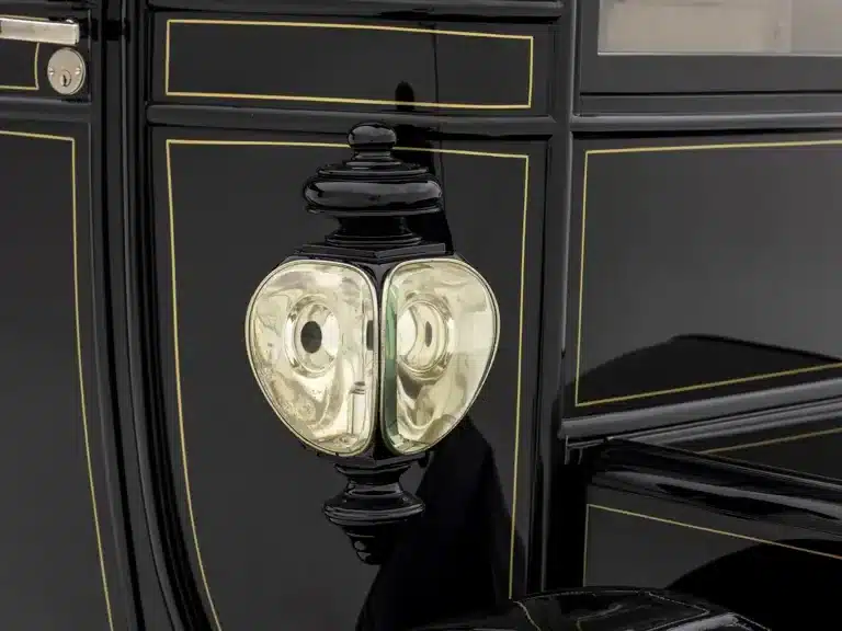 Seitliche Detailaufnahme einer historischen Laterne und der Aluminiumkarosserie mit Zierlinien eines 1912 Baker Electric Model V Special Extension Coupe
