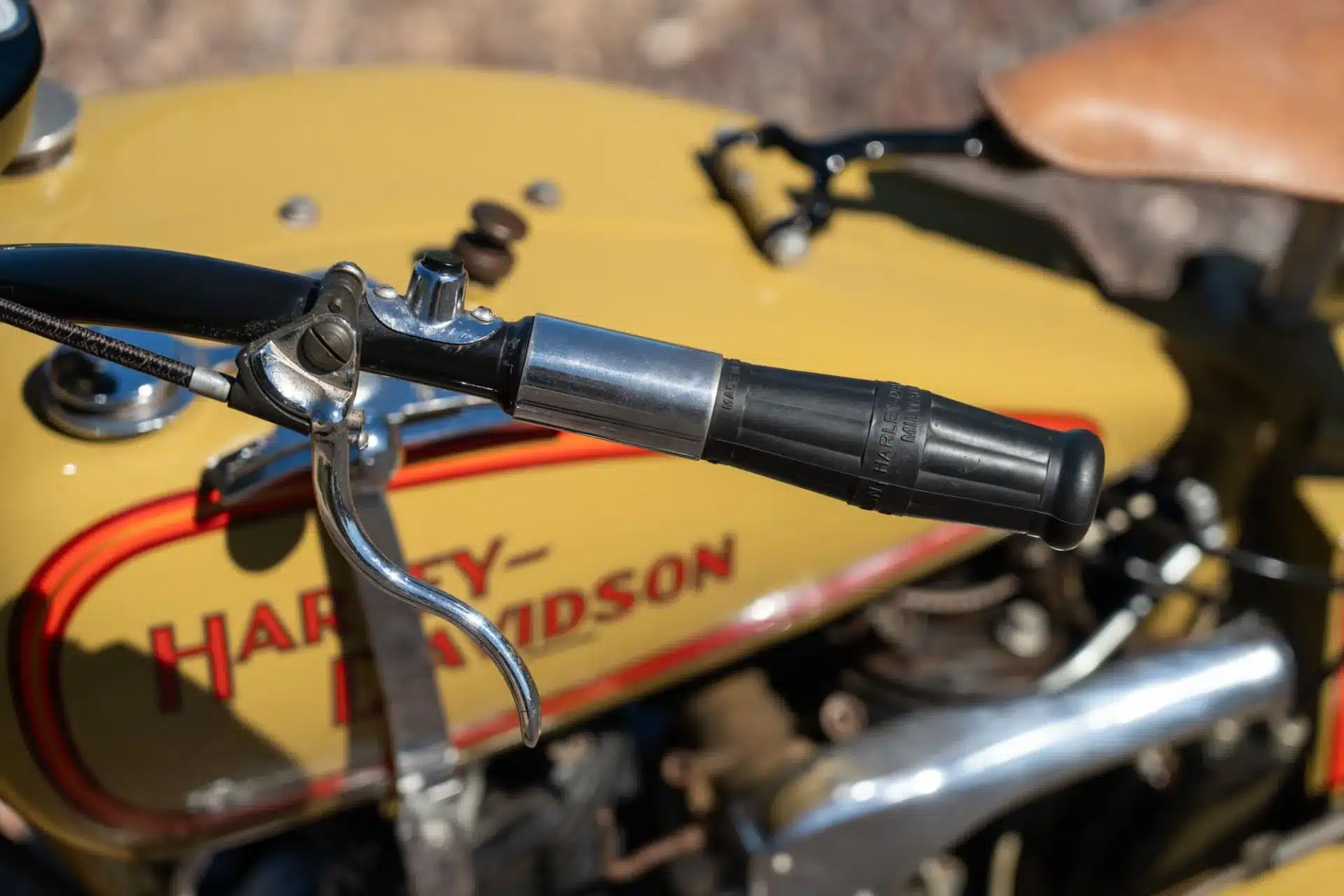 Lenkergriff und Tank einer restaurierten 1932 Harley-Davidson VL Big Twin in Gelb mit roter Zierlinie.