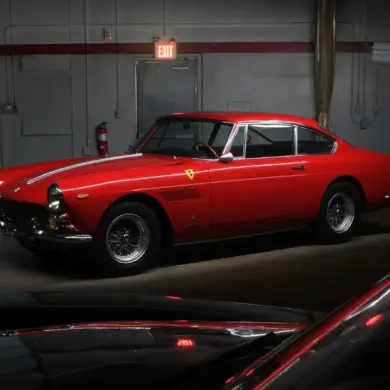 Restaurierter Ferrari 250 GTE Series III, Baujahr 1963, in roter Lackierung in einer Garage.