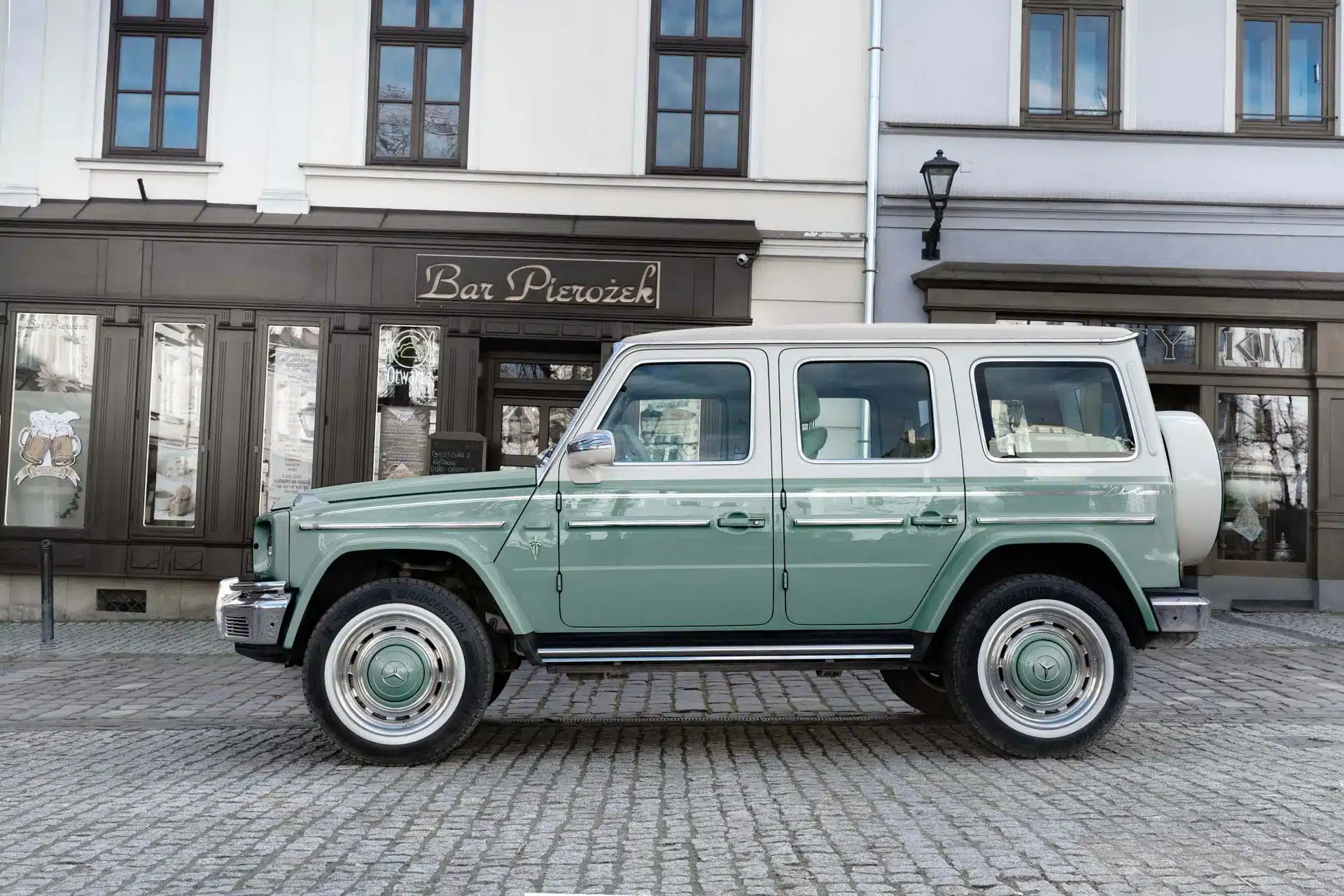 Seitenansicht eines Carlex G63 Lago Vintage in zweifarbiger Lackierung vor einem historischen Gebäude.