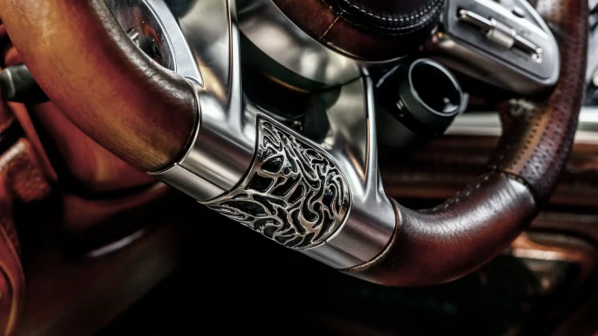 Detailaufnahme des veredelten Lenkrads im Mercedes-Benz G 63 AMG G-Falcon One of One mit graviertem Metalleinsatz und hochwertigem Leder.