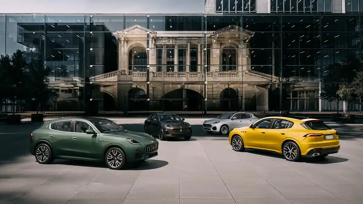 Mehrere Maserati Grecale Folgore SUV in unterschiedlichen Lackierungen vor einem gläsernen Gebäude