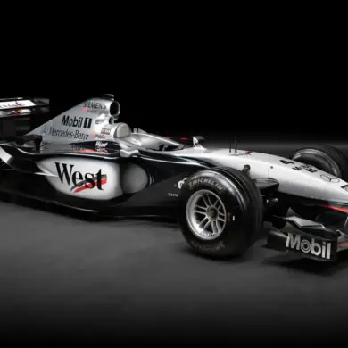 Seitenansicht des McLaren MP4-17A Formel-1-Autos mit West-McLaren-Mercedes-Lackierung auf schwarzem Hintergrund.