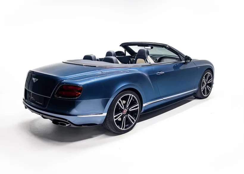 Bentley Continental GTC V8 S Cabriolet, Modelljahr 2014, blauer Lack, Seiten- und Heckansicht, Verdeck geöffnet, auf hellem Hintergrund.