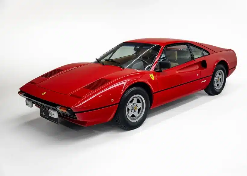 Seitenansicht eines roten Ferrari 208 GTB aus dem Jahr 1981 mit keilförmigem Design, fotografiert vor weißem Hintergrund