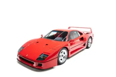 Ferrari F40 in Rosso Corsa, seitlich von vorne fotografiert vor weißem Hintergrund.