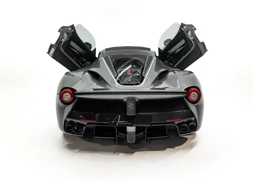 Ferrari LaFerrari Aperta in Silber/Grau, fotografiert von hinten, beide Türen geöffnet, Motor unter Glas sichtbar.