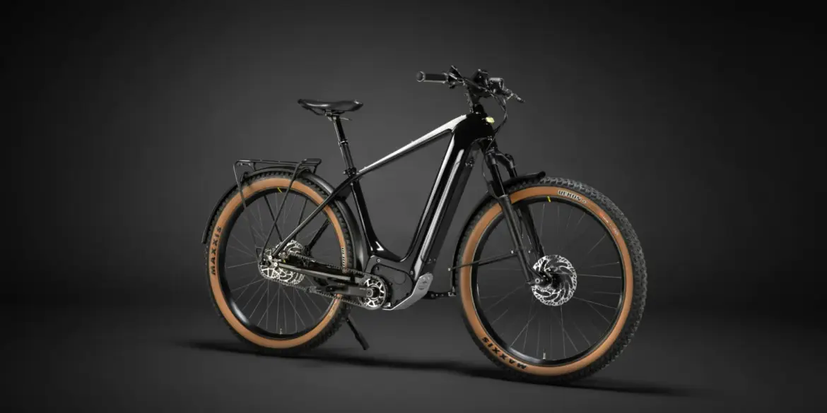 Ein schwarzes Heritage Style Escapade Elektrofahrrad steht freistehend vor einem dunklen Hintergrund.