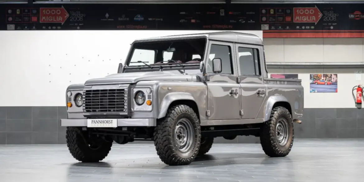 Veredelter Land Rover Defender 110 Double Cab von 2011 in Stornoway Grau, präsentiert in einer Halle.
