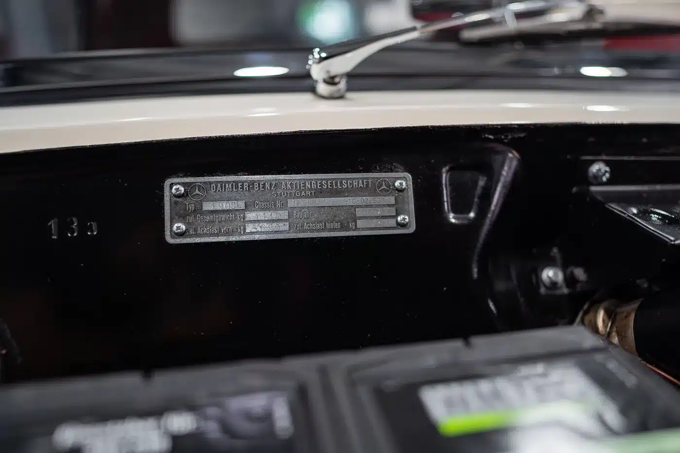 Detailaufnahme vom Fahrgestellnummernschild und technischen Daten im Motorraum eines Mercedes-Benz 190 SL