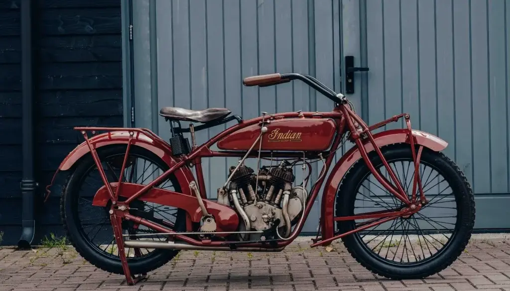 1925 Indian Scout Motorrad, restauriert, im originalen roten Lack, vor Garagentor fotografiert.