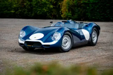 Lister-Jaguar Knobbly Continuation in Blau auf Schotter, Rennsport-Silhouette von vorn schräg fotografiert.