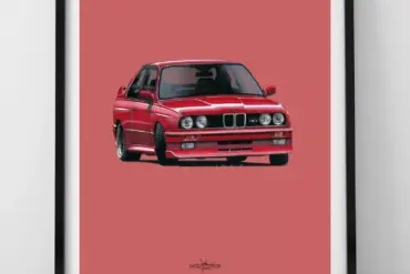 Kunstdruck eines roten BMW E30 M3 vor rosa Hintergrund, eingerahmt und auf den Boden gestellt