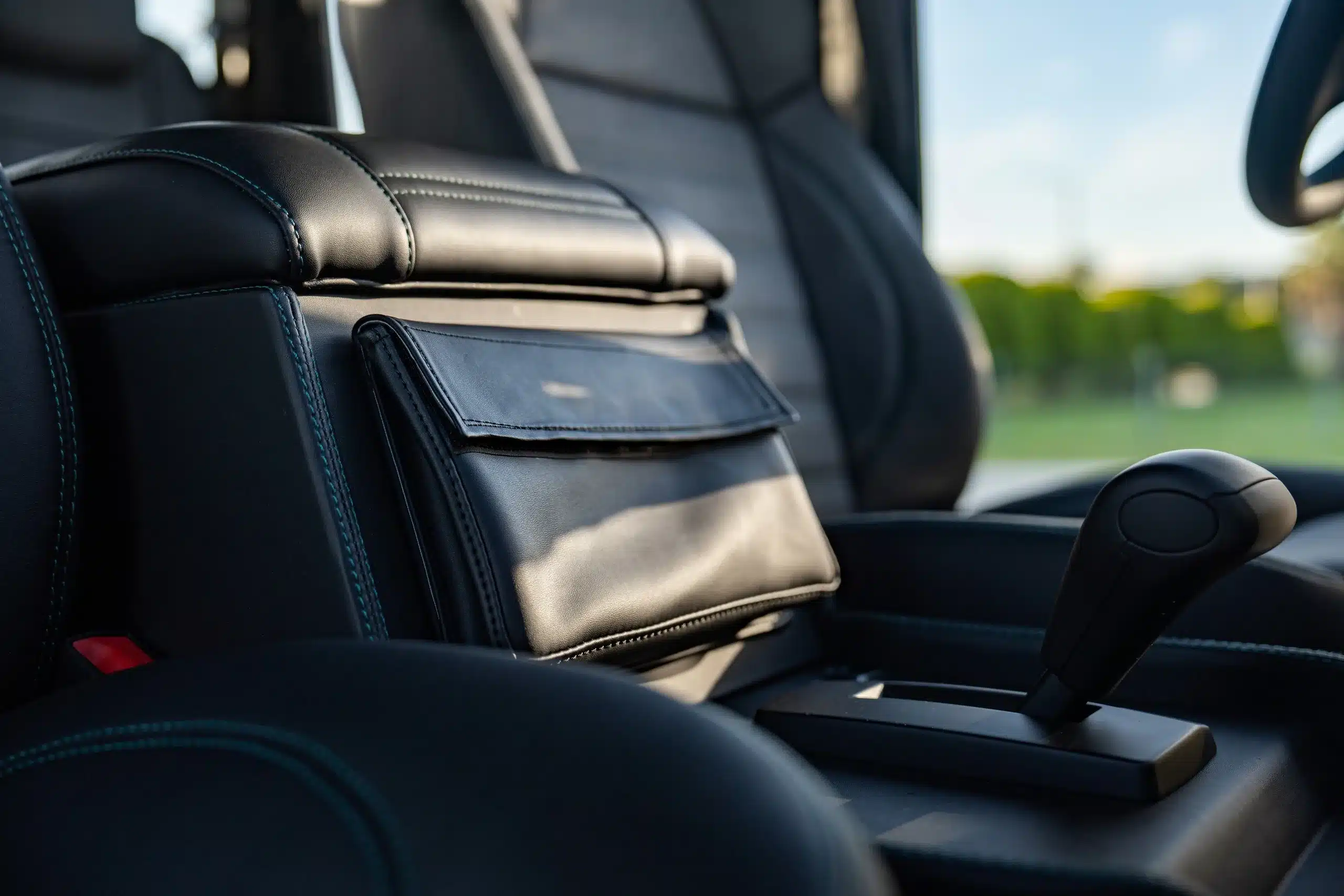 Innenraum mit Armlehne und Schalthebel eines elektrischen Land Rover Defender 110 (1989)