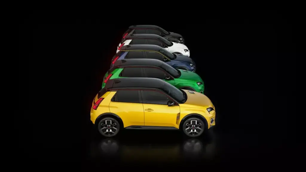 Mehrere Renault 5 E-Tech Electric Modelle in Seitenansicht und unterschiedlichen Farben vor schwarzem Hintergrund.