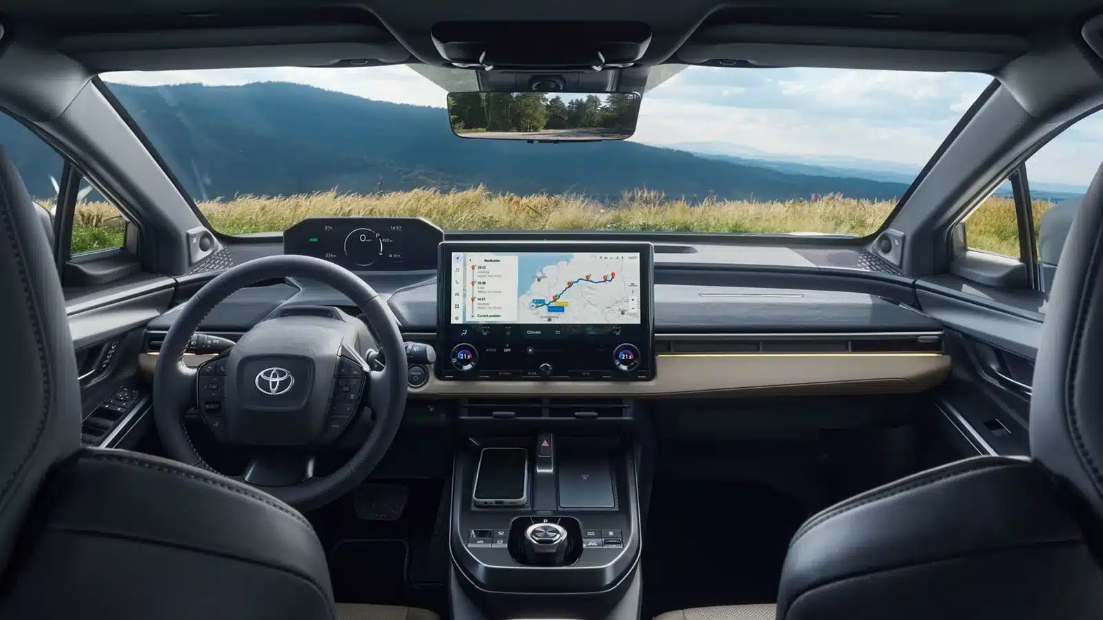 Innenraum des Toyota bZ4X Touring mit großem Touchscreen und weitem Ausblick durch die Frontscheibe.