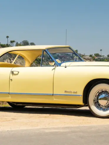 Seitenansicht eines gelben 1952 Muntz Jet Cabriolets vor natürlicher Kulisse