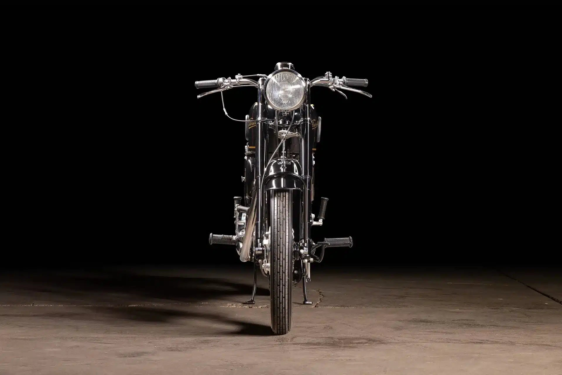 Frontansicht einer restaurierten Velocette MAC 350 von 1953 vor schwarzem Hintergrund.