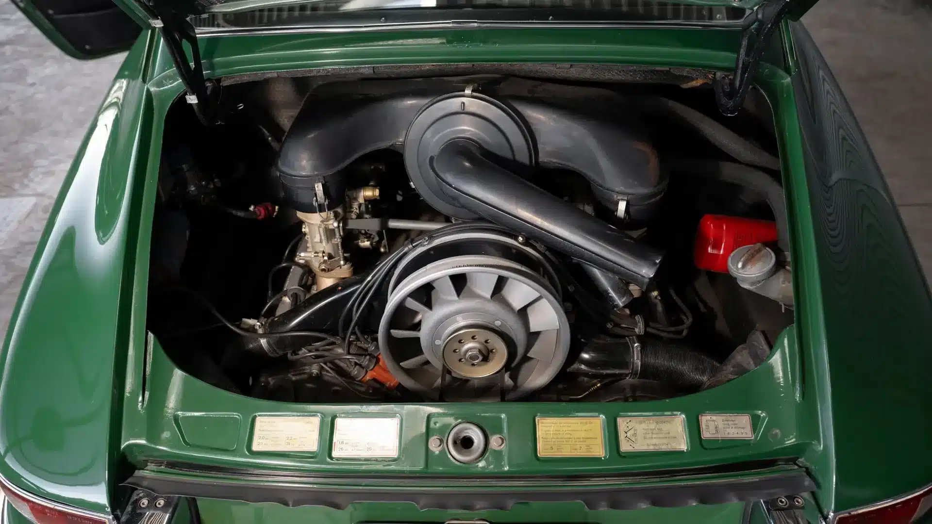 Blick in den Motorraum eines Porsche 911 Coupé von 1966 mit originalem Sechs-Zylinder-Boxermotor in Irish Green.