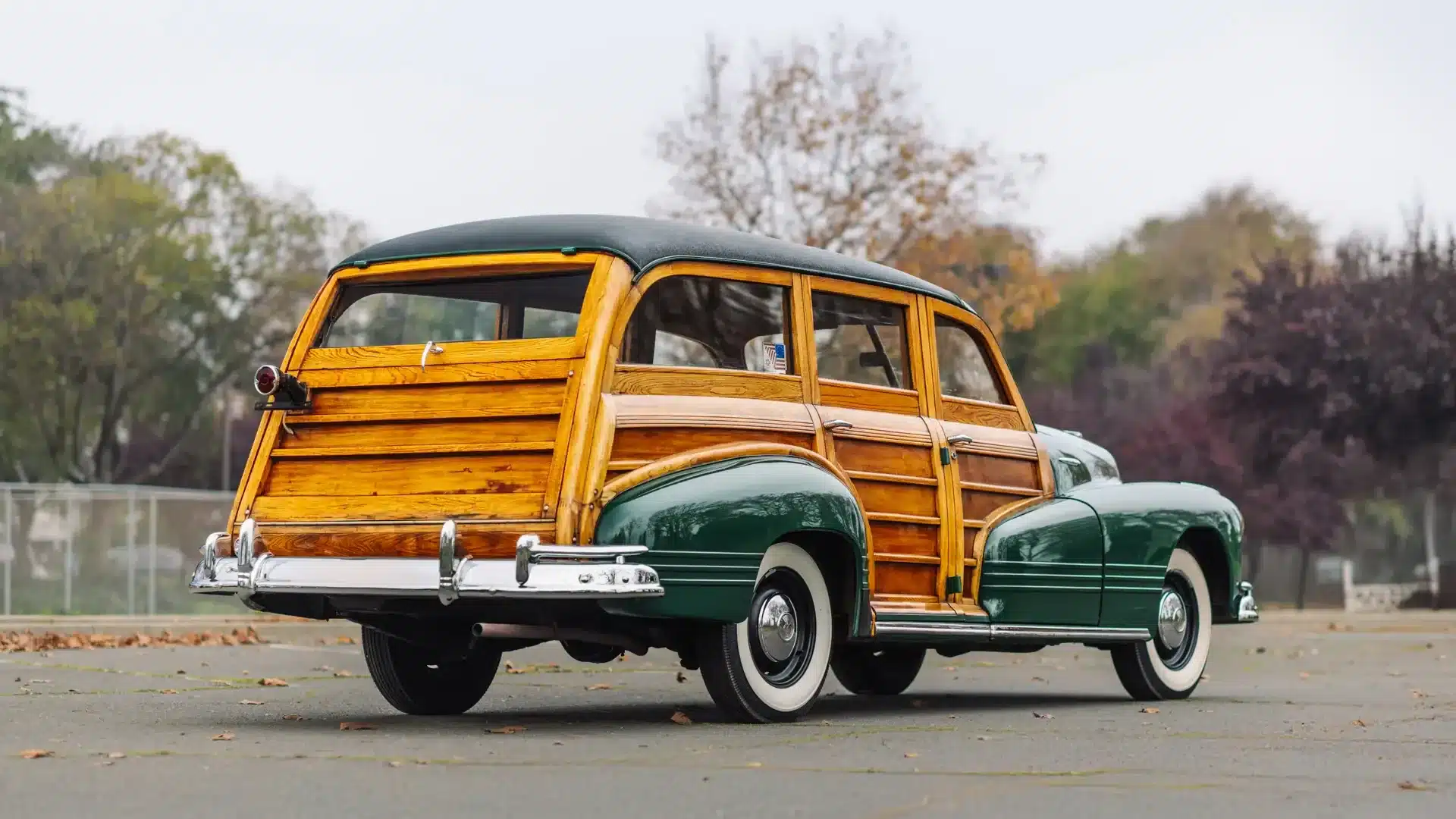 Heckansicht eines 1947 Pontiac Streamliner Eight Station Wagon mit grüner Lackierung und originalem Holzaufbau auf leerer Straße.