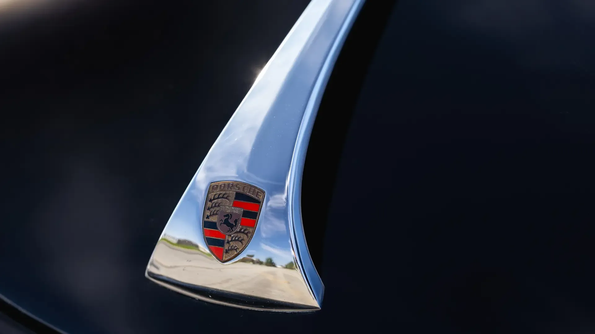 Nahaufnahme des Porsche-Logos auf schwarzer Karosserie eines Porsche 356 B Super 90 Roadster by Drauz