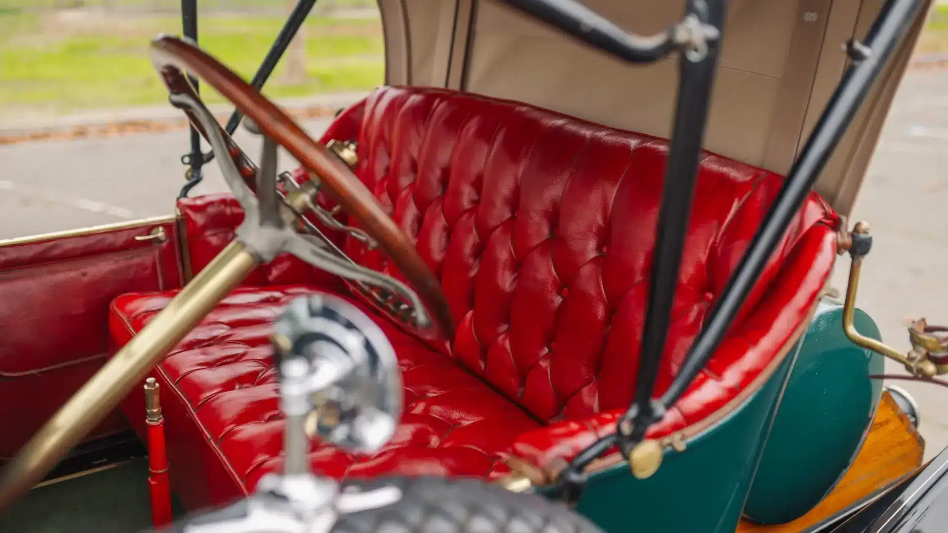 Rotes Lederinterieur und Holzlenkrad eines Herreshoff Model 30 Runabout von 1913