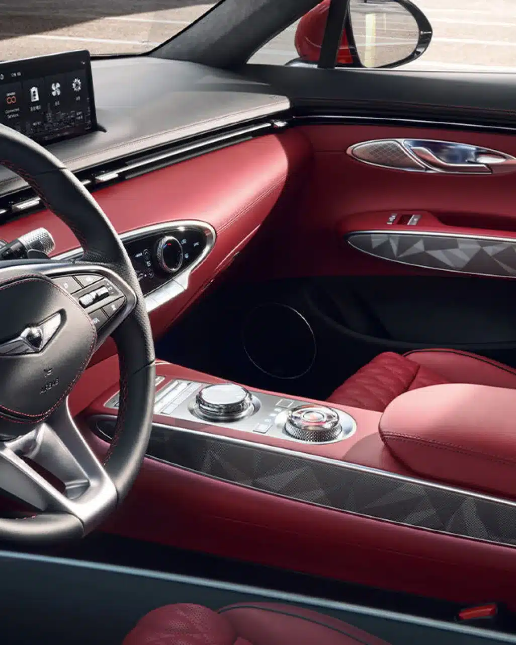 Detailansicht des roten Innenraums und Cockpits im Genesis GV70 SUV