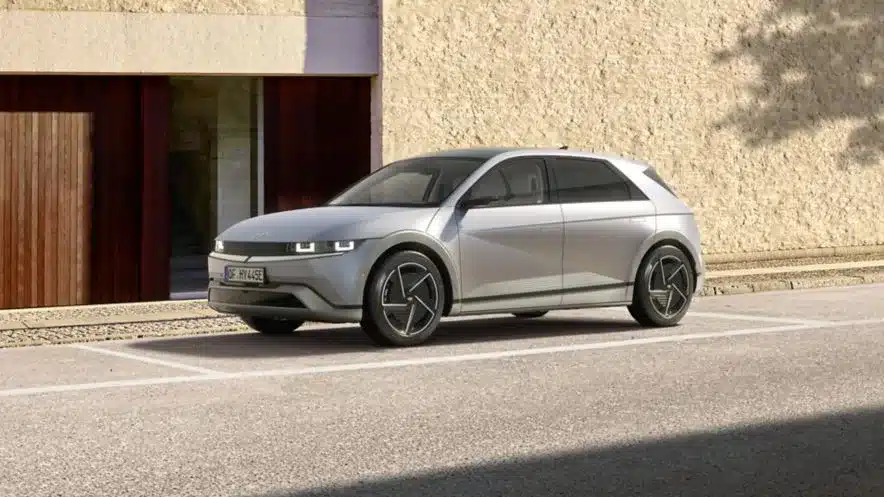 Silberner Hyundai IONIQ 5 steht geparkt vor einer hellen Wand.