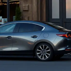 Mazda3 Fastback 2024 in Seitenansicht geparkt vor einem repräsentativen Gebäude