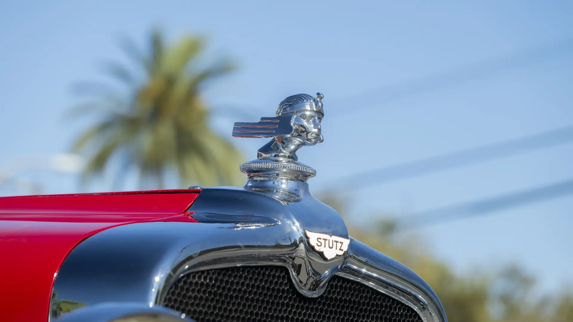 Detailaufnahme der Kühlerfigur und des Stutz-Emblems auf der Motorhaube eines Stutz Black Hawk Speedster von 1928.