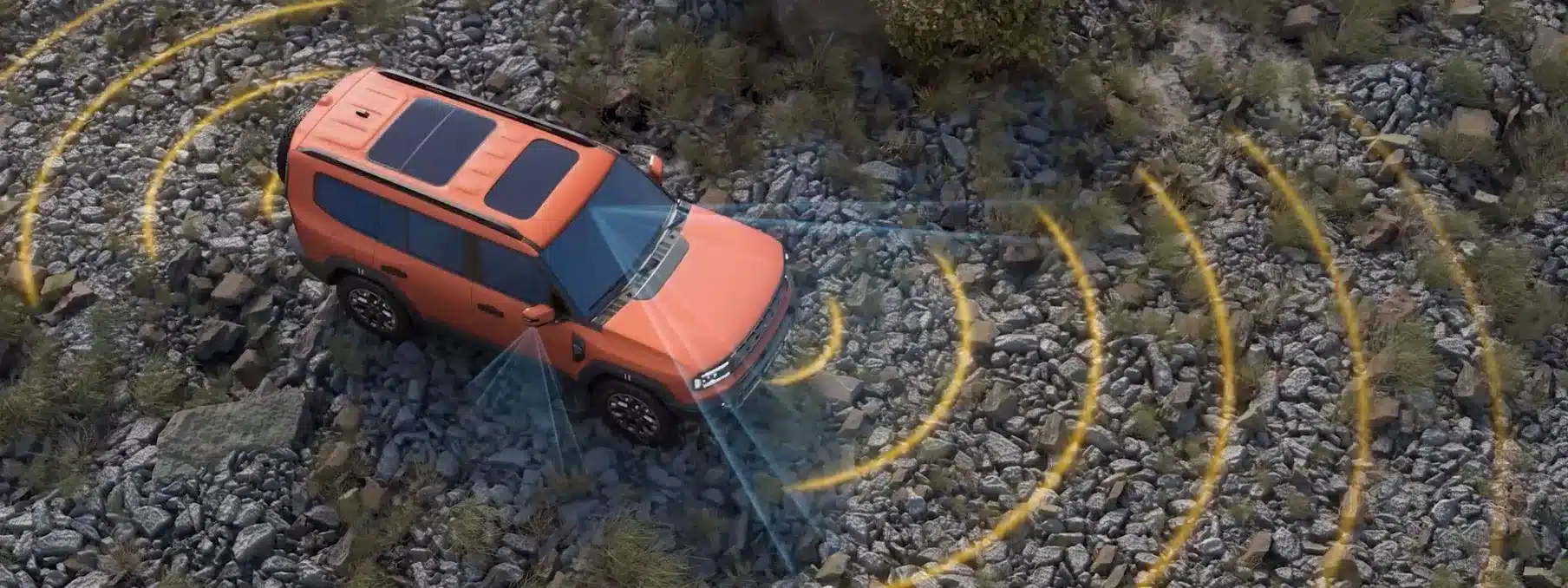 Jetour G700 SUV in Orange auf felsigem Untergrund, dargestellt mit Sensor-Reichweiten für Assistenzsysteme aus der Vogelperspektive.