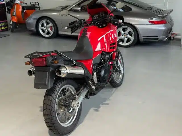 Rote Triumph T900 Tiger von hinten in einer Garage, klassische Reiseenduro