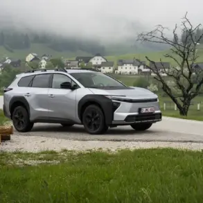 Silberner Toyota bZ4X Touring als Elektro-SUV auf einer Landstraße in bergiger und bewaldeter Umgebung