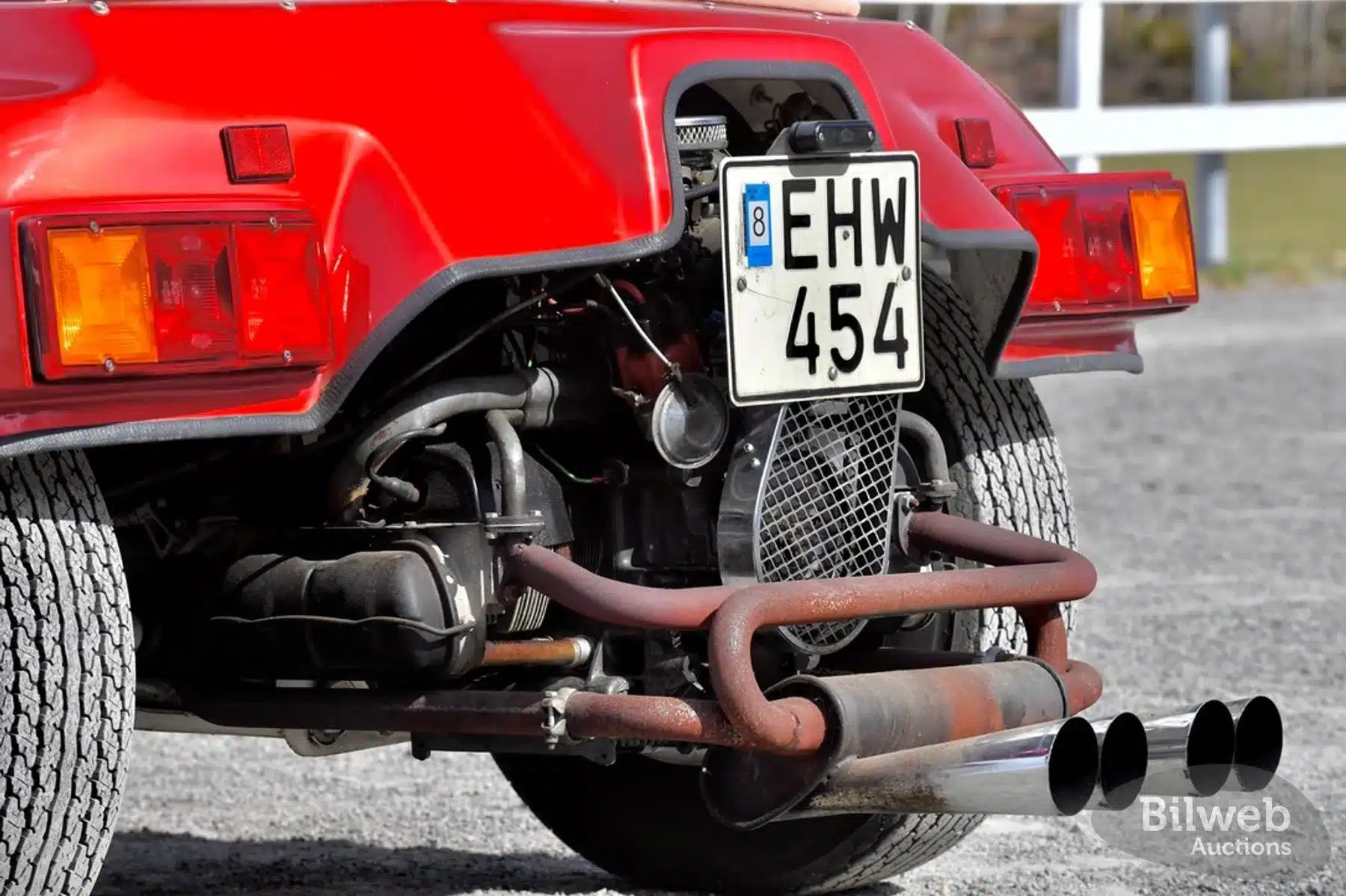 Heckpartie eines roten Beach Buggy 1300 mit schwedischem Kennzeichen und freiliegender, seitlicher Auspuffanlage (bundle of snakes)