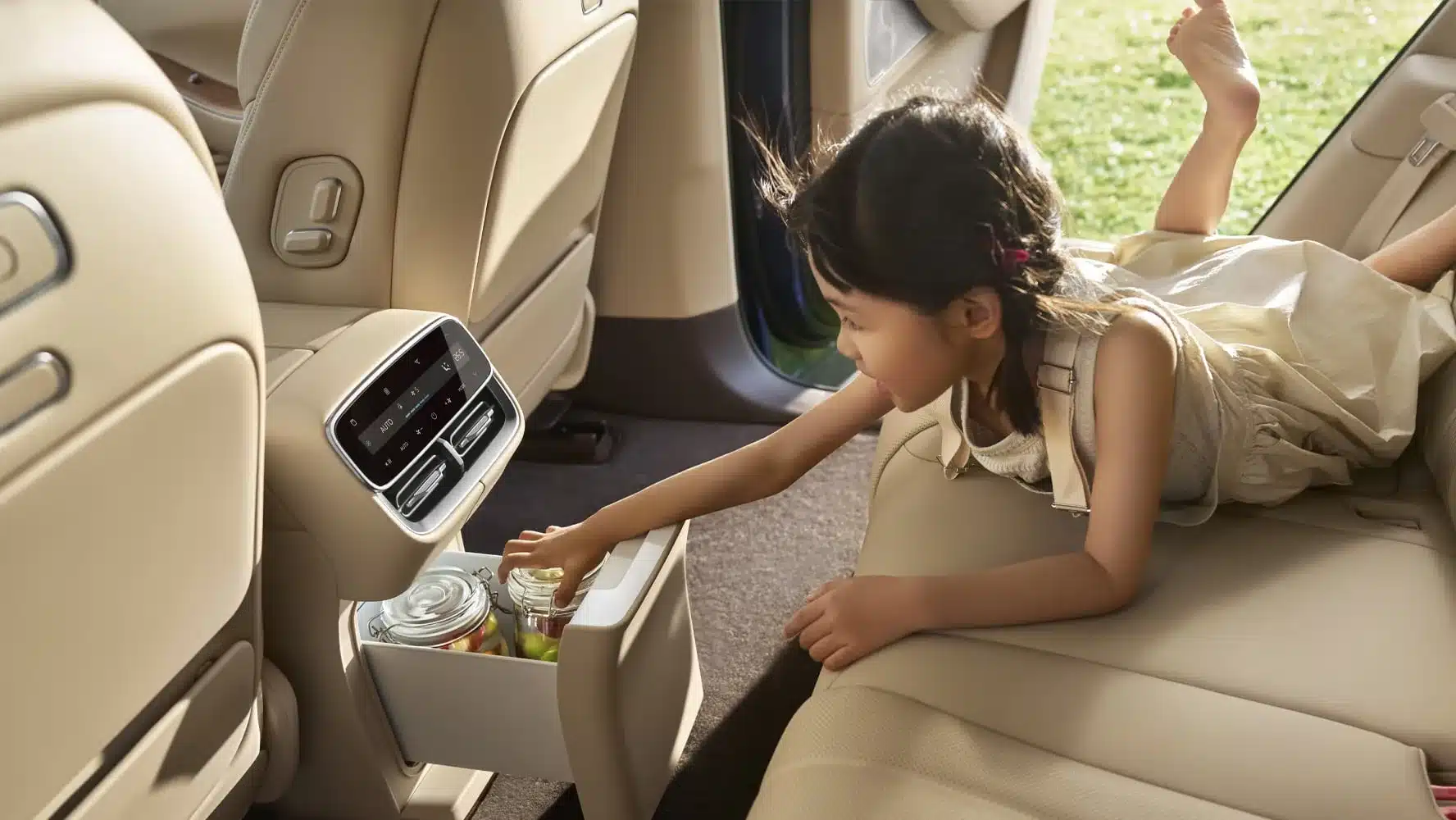 Kind im Innenraum des Wenjie M7 SUV, greift in den integrierten Kühlschrank der Mittelkonsole.