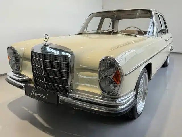 Beiger Mercedes-Benz 250 SE W108 mit Airride-Fahrwerk und BBS-Leichtmetallrädern, fotografiert frontal in heller Umgebung