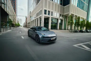 ZEEKR 001, grauer Elektro-Shooting Brake, fährt durch eine Innenstadt mit modernen Gebäuden.