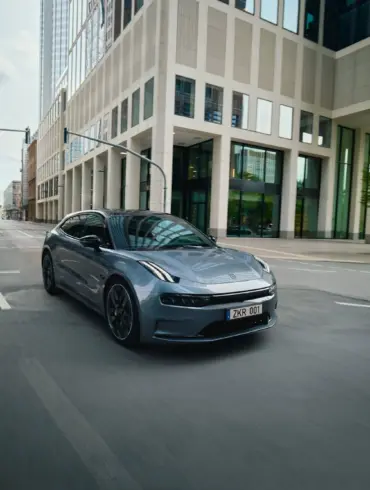 ZEEKR 001, grauer Elektro-Shooting Brake, fährt durch eine Innenstadt mit modernen Gebäuden.