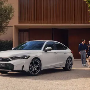 Weißer Honda Civic e:HEV steht vor einem modernen Haus, im Vordergrund ein Paar mit Hund.