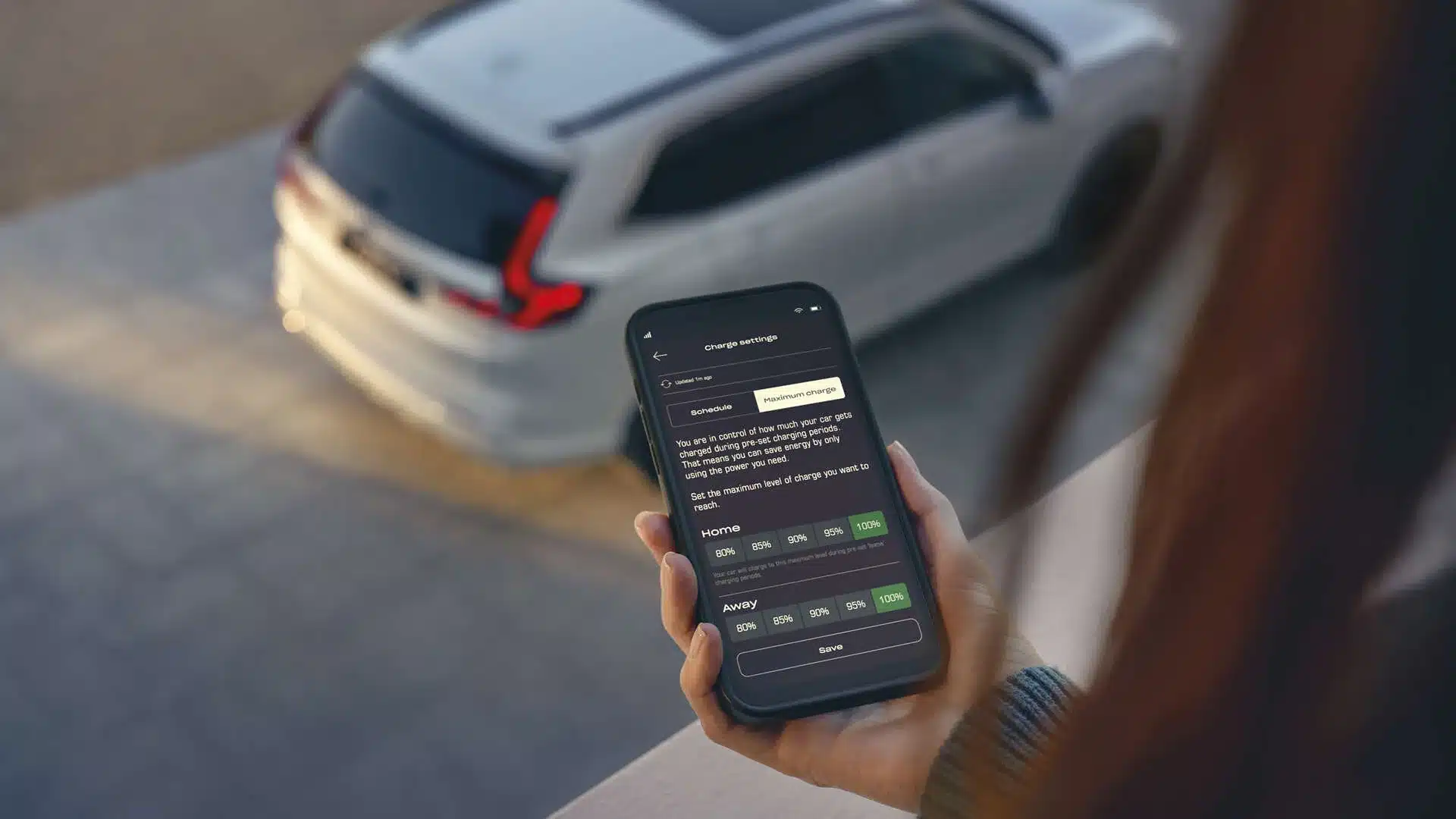 Smartphone mit Ladesoftware, im Hintergrund ein Honda CR-V Plug-in-Hybrid von oben