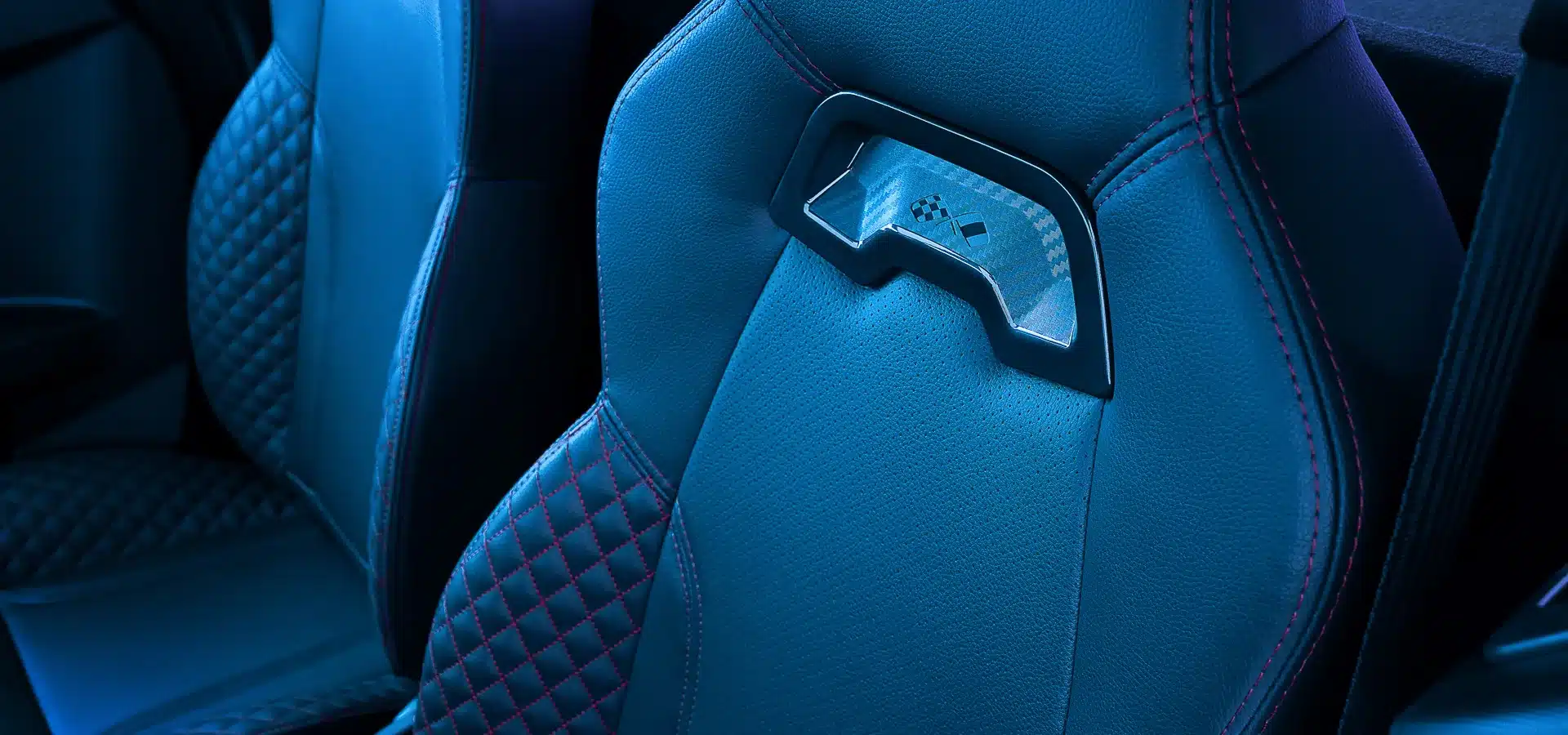 Detailaufnahme eines modernen, sportlichen Autositzes aus veganem Leder mit roten Ziernähten im Ligier JS50