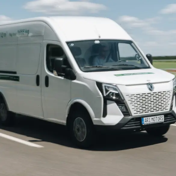 Weißer ARI 1710 Elektro-Transporter fährt auf einer Landstraße bei Tageslicht.