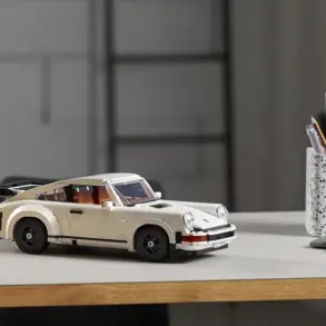 LEGO Porsche 911 Turbo Modellauto in weiß auf einem Tisch, im Hintergrund Büro-Utensilien