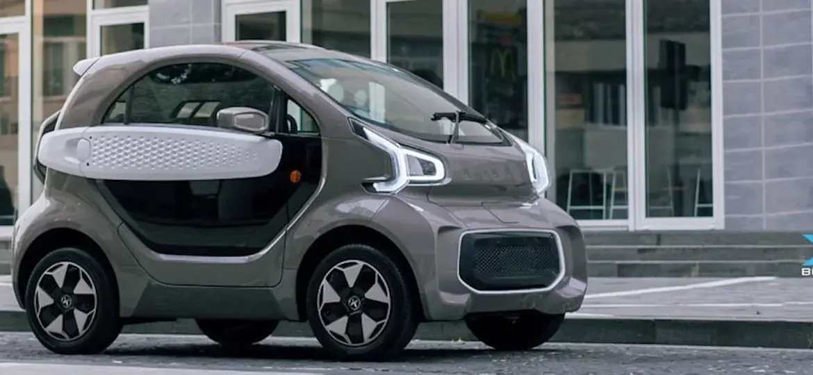 XEV YOYO, ein kleines, modernes Elektroauto für die Stadt, seitlich vor Gebäuden geparkt