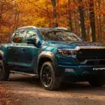 Foton 4 Pickup in blauer Lackierung auf einem Waldweg im Herbst