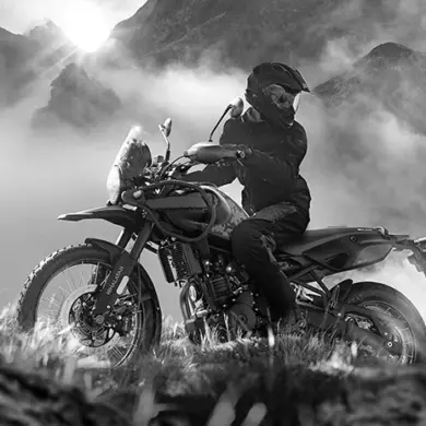Royal Enfield Himalayan 450 Motorrad im Gelände mit Fahrer vor bergiger Landschaft